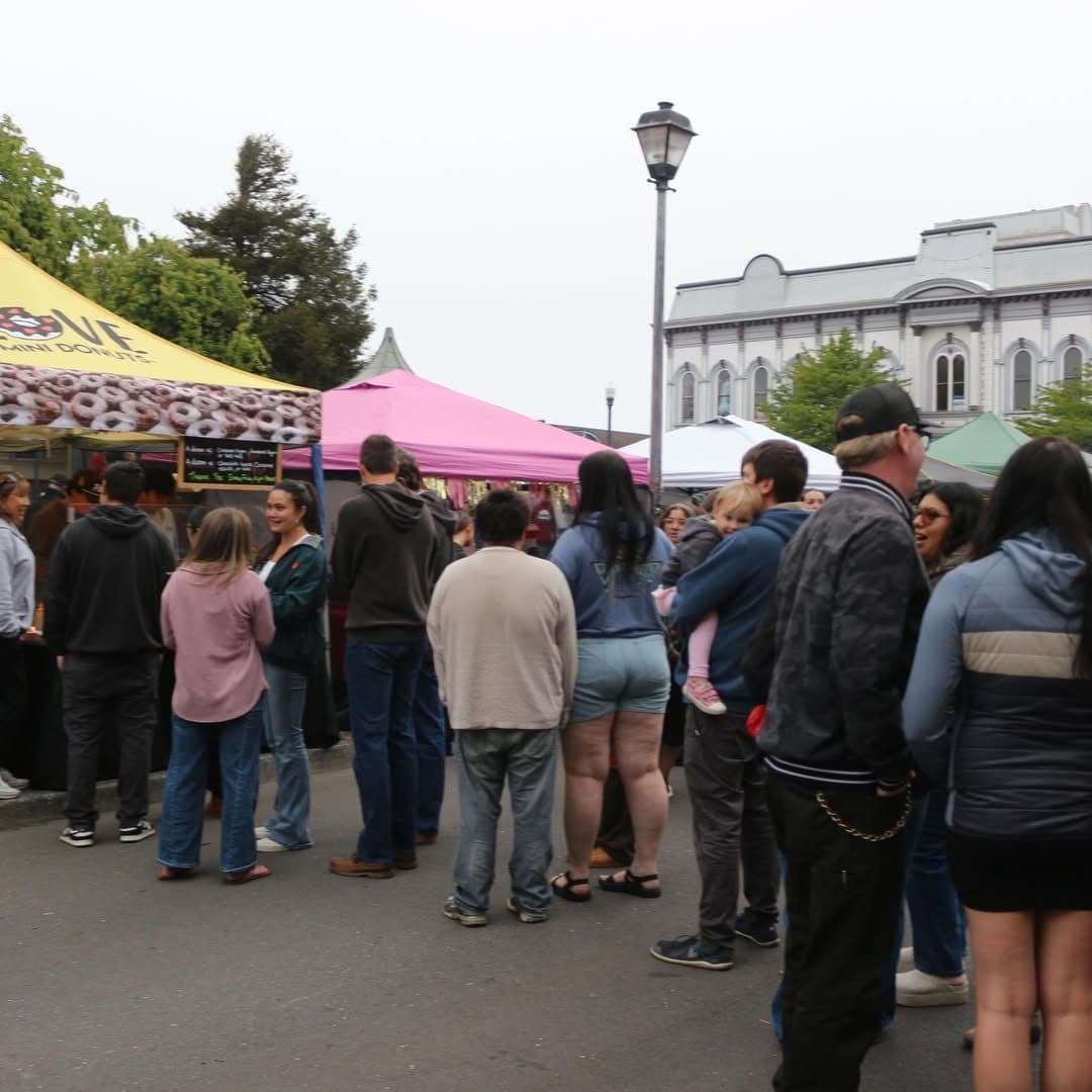 The Friday Night Market in Old Town Eureka. Handmade booths and food vendors share the same block.