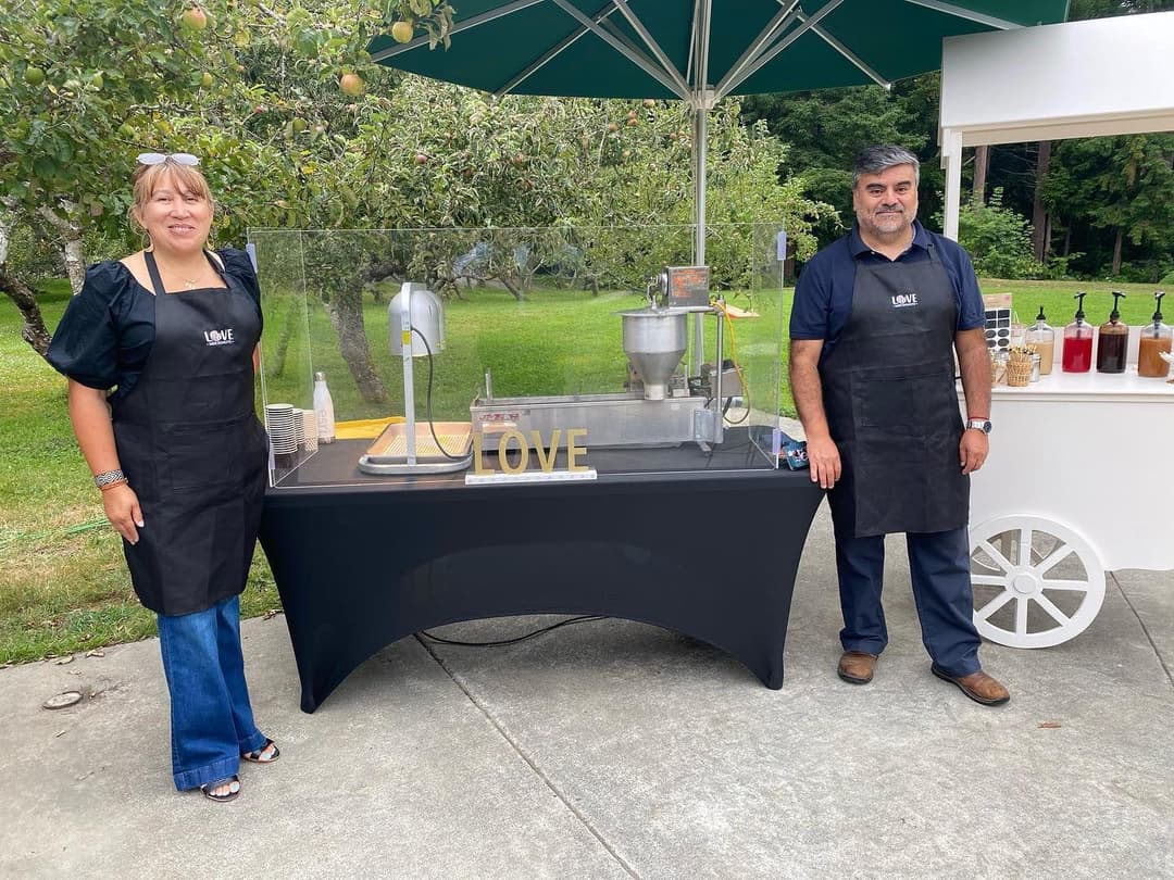 Fifteen years of setups: the cart at an outdoor event, and the tent with the fryer under it.